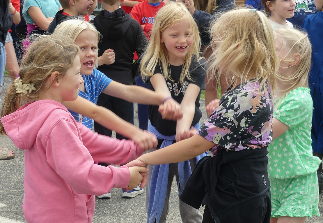 First grade students Hailey Rosenbeck (center), Jordan Shannon (left), Bristol Bruggeman (left), Natalie Alig (right), and Rachel Muhlenkamp (right) dance in celebration at Bloomfield Elementary's last day of school extravaganza. (Lindy Mercer)