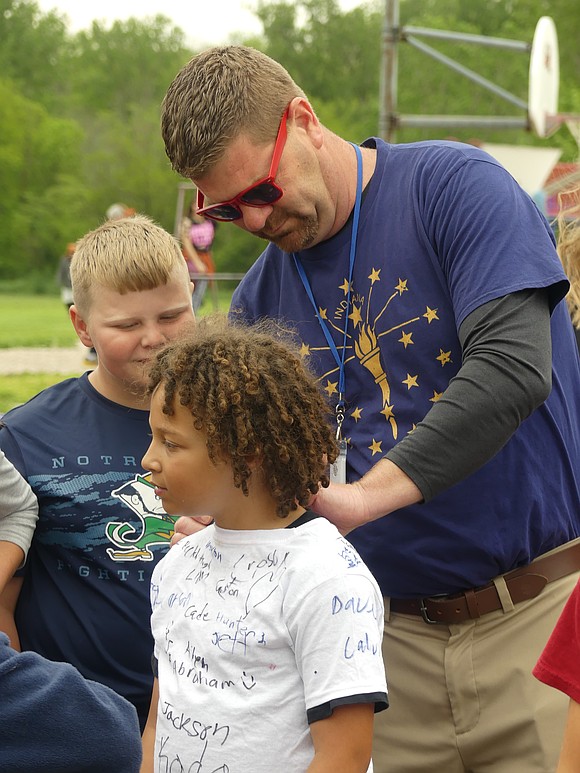 Principal Ben Dues signs a student's shirt to commemorate the 2024-2025 school year. Mr. Dues says that this year was a "bookend year of Bloomfield pulling together as a staff". He also said that this year flew by the fastest of all his years as principal. (Lindy Mercer)