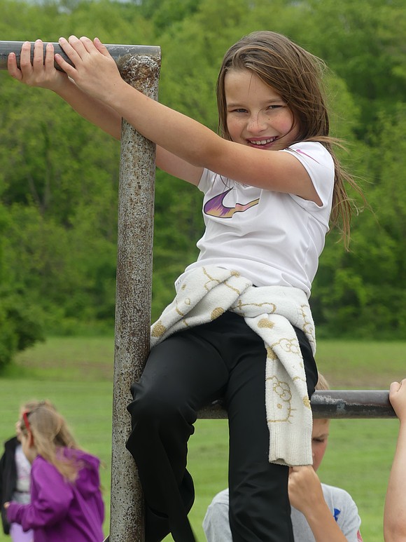 Raelee Chownings, third grade, celebrated the last day of school on the playground equipment. This summer, Raelee is looking forward to going to the beach in Florida. (Lindy Mercer)