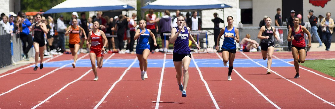 Fort Recovery High School senior Anna Roessner runs well ahead of the field in the 400-meter dash during Saturday’s Division III district meet at Piqua. She won the 100 dash, 200 dash and 400 dash, all in district record times. Her 200 dash time also broke her own school record. (The Commercial Review/Ray Cooney)