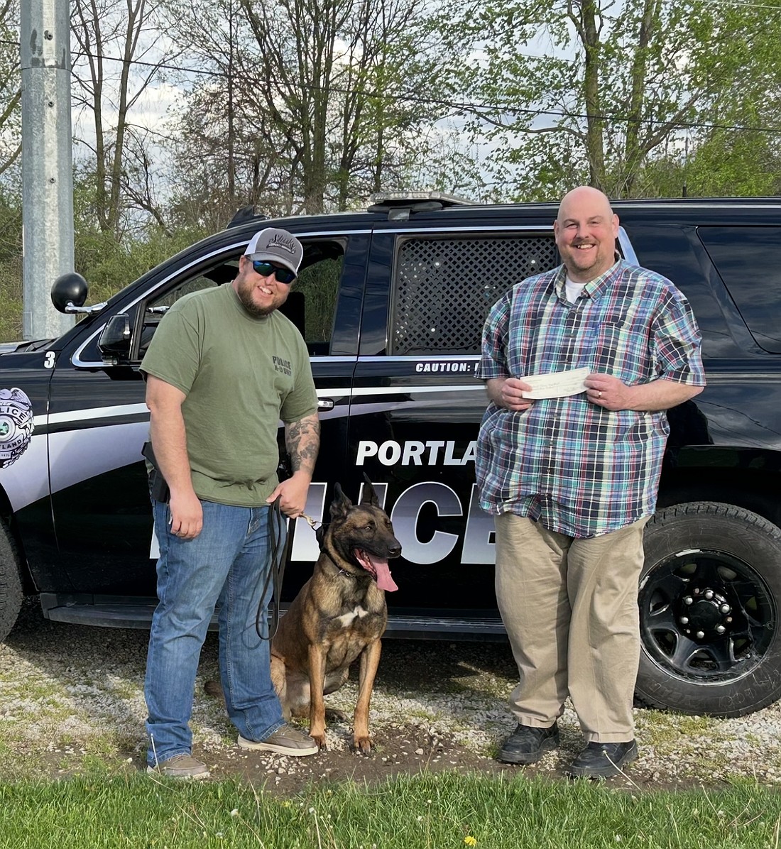 Portland Lions Club recently donated funds to purchase a ballistic vest for Portland Police Department’s K9 officer, Spyke. Pictured above is Portland police officer and K9 handler Brandon McDavid with Spyke and Portland Lions Club secretary Paul Szymczak. (Photo provided)