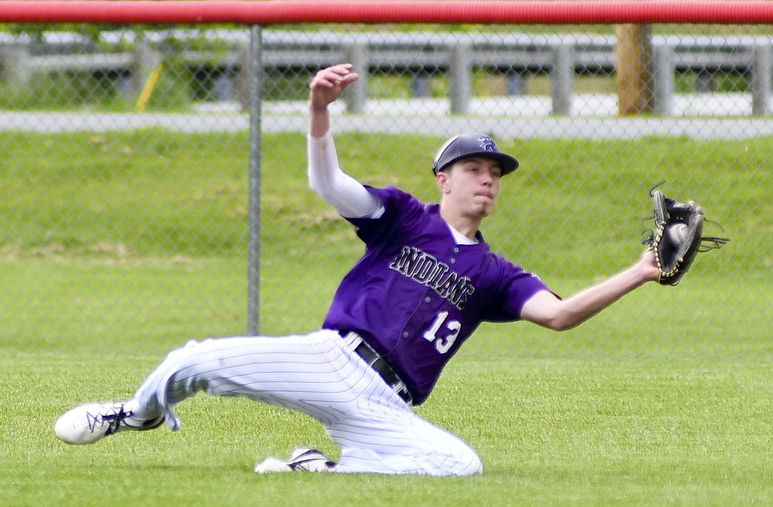 Fort Recovery High School right fielder Mason Diller makes a sliding catch during the Indians’ 2-1 victory over sixth-seeded Legacy Christian in nine innings at Houston during the OHSAA Division VI Southwest 3 District title game on Friday. Diller also made a key defensive play that saved a run in the first inning of the game as well. (The Commercial Review/Andrew Balko)