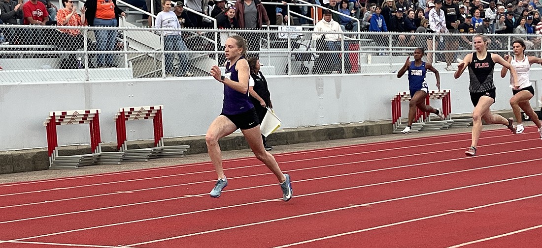 Fort Recovery High School senior Anna Roessner zips to the finish line well ahead of the rest of the field in the 200-meter dash during Friday night’s Division III regional track meet at Troy. She won the 200 dash going away and also scored massive victories in the 100 dash and 400 dash to earn regional championships and state berths in all three events. She will compete in the OHSAA Division III Track and Field State Finals, which begin with preliminaries on Friday at Jesse Owens Memorial Stadium on the campus of Ohio State University in Columbus. (The Commercial Review/Ray Cooney)