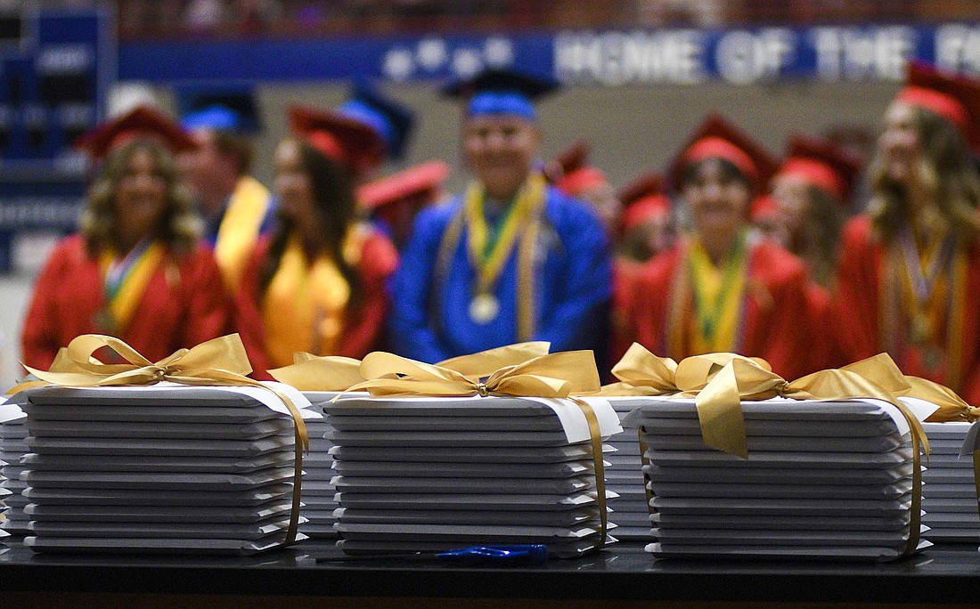 Diplomas sit stacked on a table Sunday early in the commencement ceremony at Jay County High School. This year marked the 50th graduating class of the school that opened in 1975. (The Commercial Review/Ray Cooney)