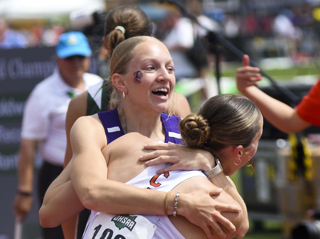 Anna Roessner of Fort Recovery High School spins Coldwater’s Izzy Zahn while hugging her after they finished atop the standings Saturday in the 400-meter dash in the OHSAA Division III Track State Finals at Ohio State University’s Jesse Owens Memorial Stadium in Columbus. Roessner won the 100 dash earlier in the day to become the first state champion in FRHS girls track history. For more on her day at the state finals, "No one faster." (The Commercial Review/Ray Cooney)