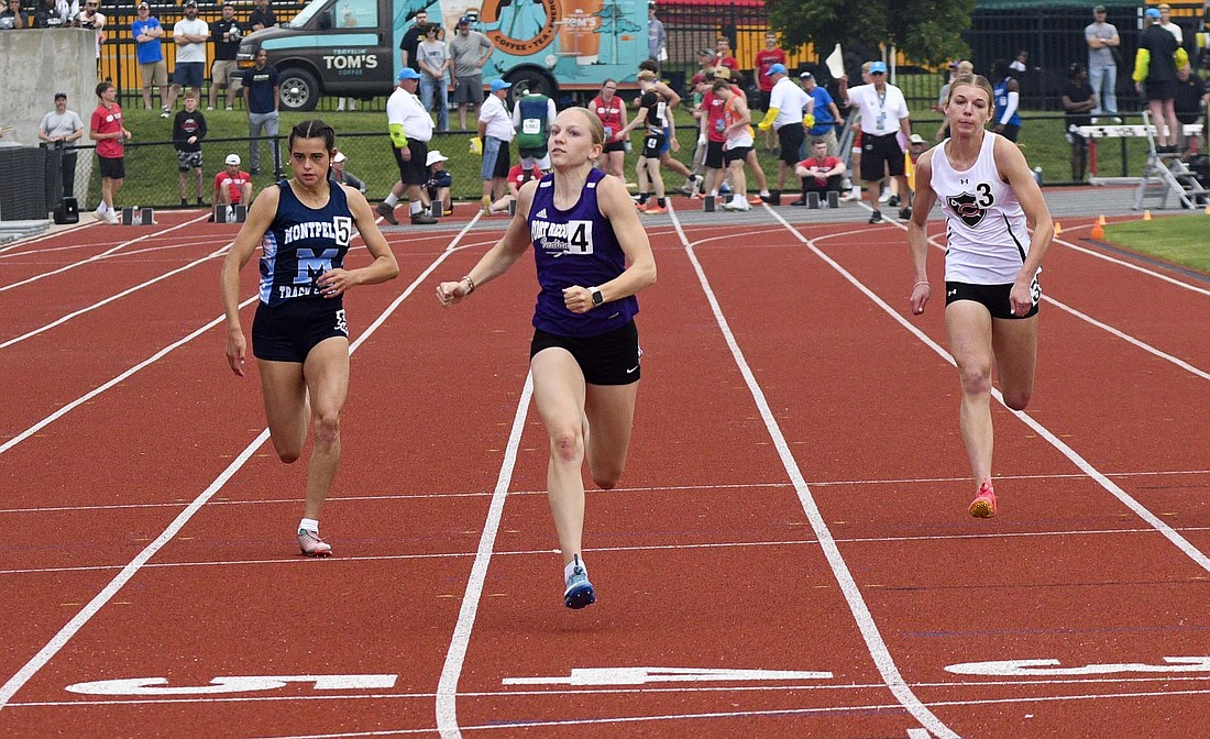 Fort Recovery High School’s Anna Roessner nears the finish line as she runs between Bria Friend of Montpelier and Claire Bertke of Coldwater during the 100-meter dash in the OHSAA Track and Field State Finals at Ohio State University’s Jesse Owens Memorial Stadium. Roessner won the state championship in the race while breaking the state meet record and matching the all-time Division III record. (The Commercial Review/Ray Cooney)