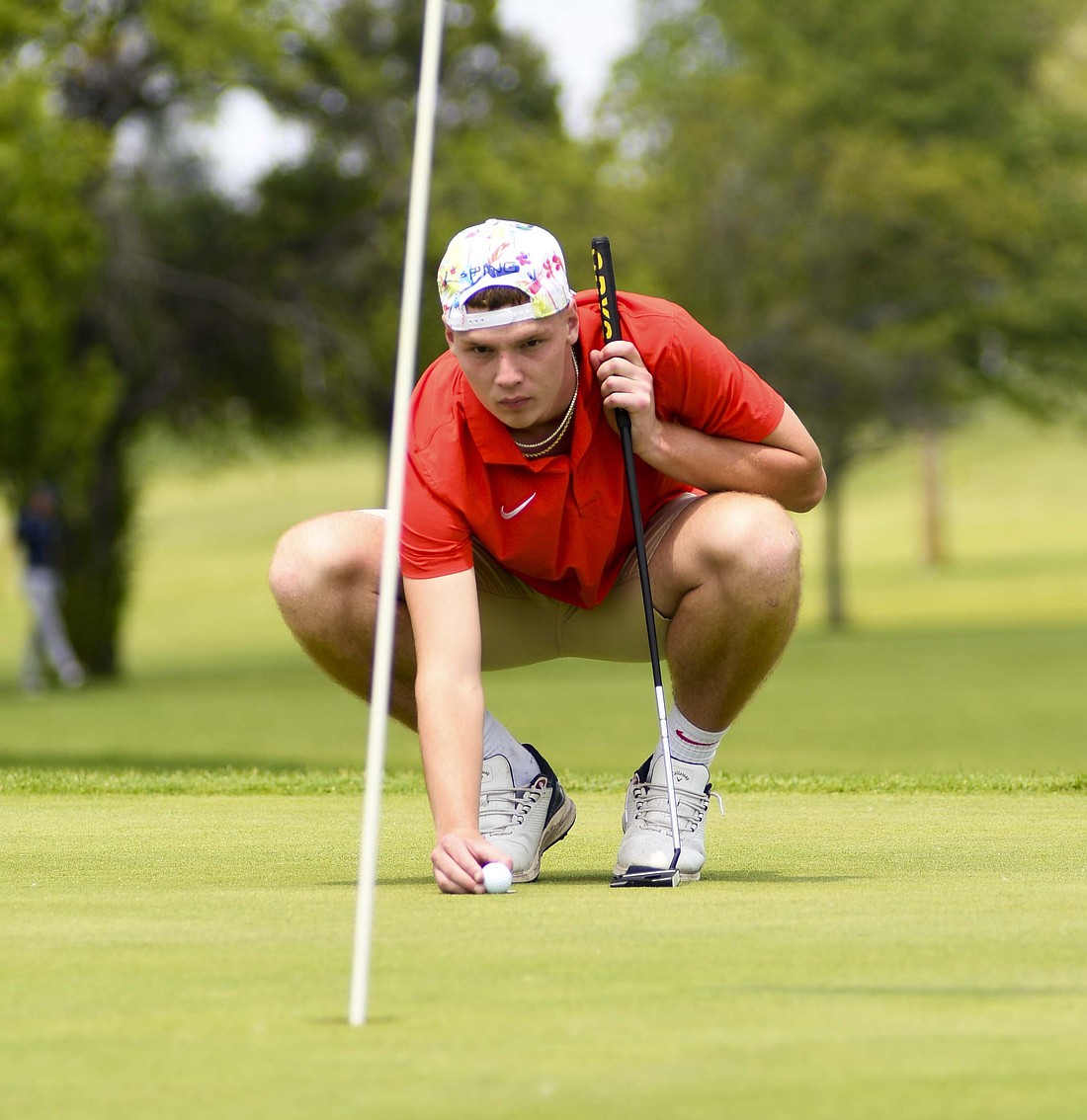 Jay County High School’s Tucker Griffin places his ball on the 18th green at Hickory Hills Golf Club while trying to find a line during the IHSAA Sectional 19 hosted by Monroe Central on Tuesday. Griffin carded an 84, falling one stroke short of his own regional berth, while the team finished fourth with a 347. (The Commercial Review/Andrew Balko)