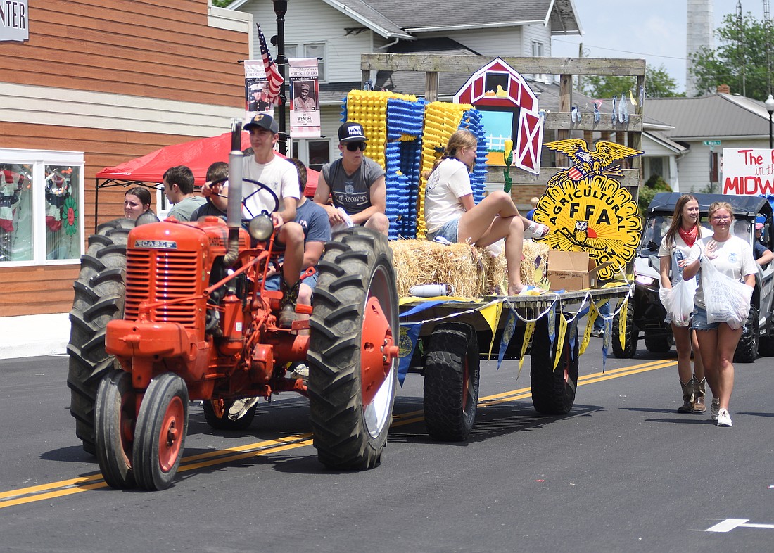 The Fort Recovery Harvest Jubilee came to a close Sunday with festivities including the parade in the afternoon. Pictured above, the Fort Recovery FFA float makes its way down Butler Street toward its intersection with Wayne Street. Below, Miss Jay County Fair Queen Molly Muhlenkamp waves to those in attendance along the parade route. (The Commercial Review/Ray Cooney)