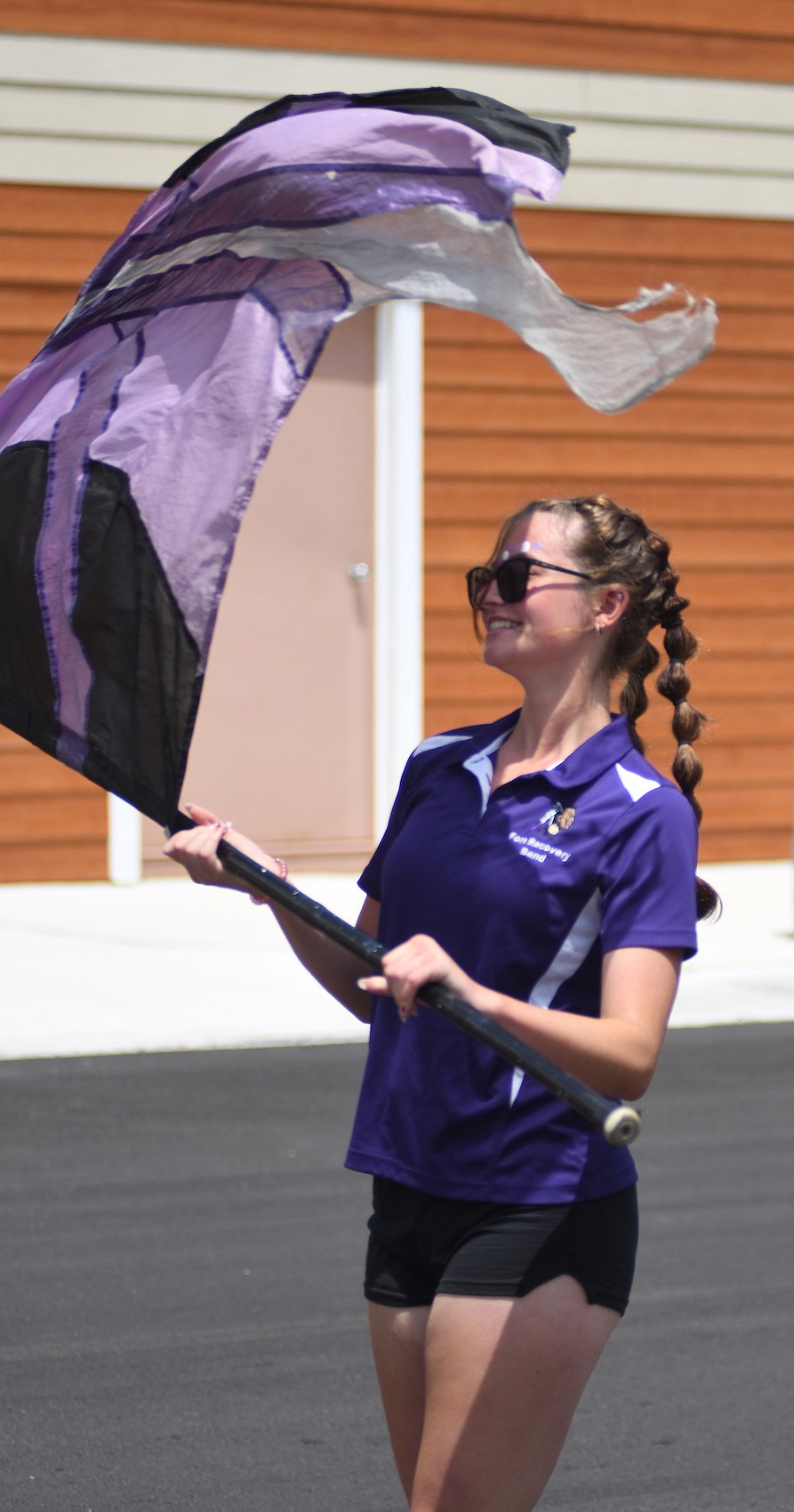 Aubree Heitkamp spins her flag while performing with the Fort Recovery High School Marching Band during Sunday’s parade at the conclusion of the Fort Recovery Harvest Jubilee. (The Commercial Review/Ray Cooney)