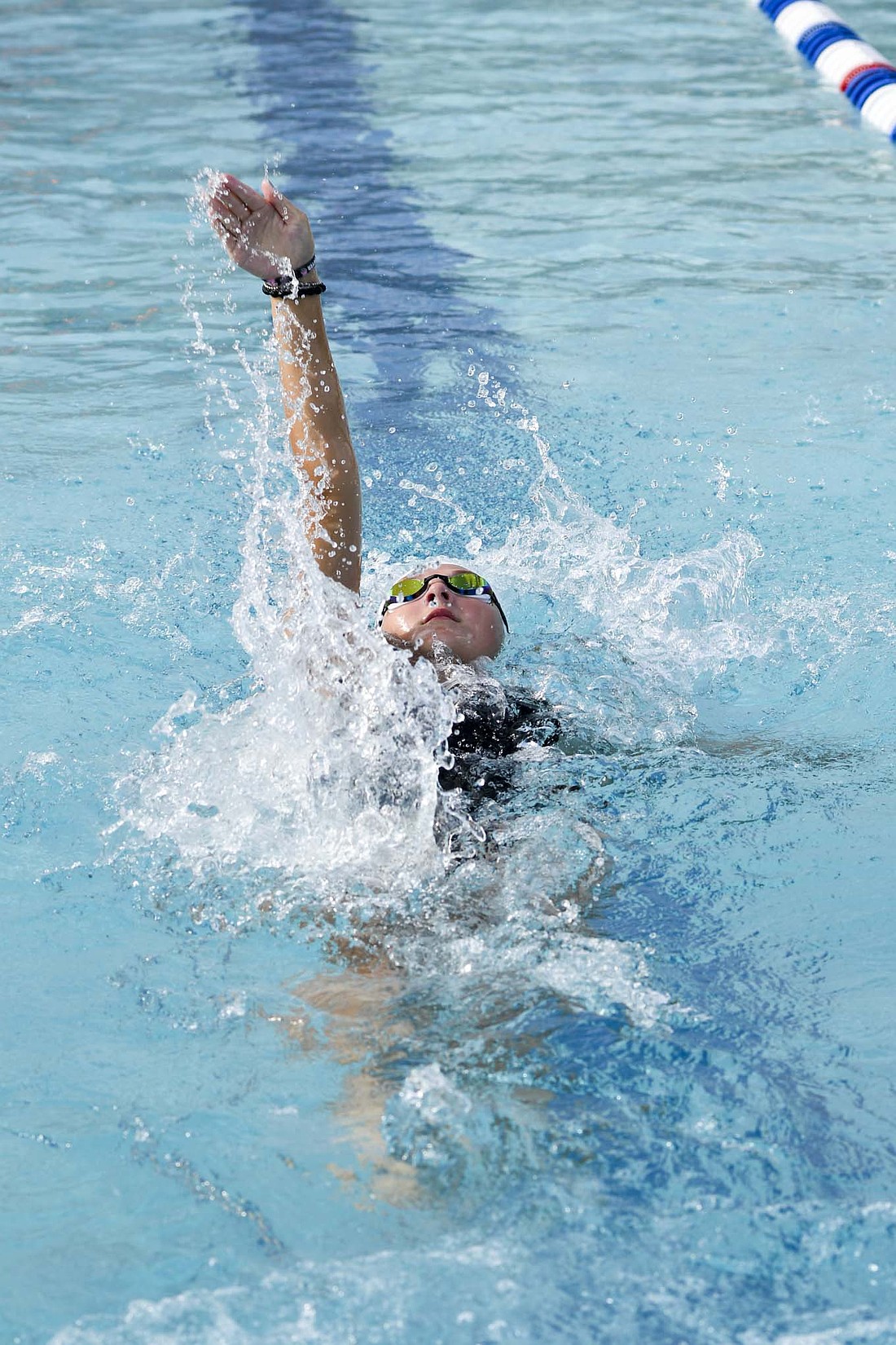 Maddy Timmerman of the Fort Recovery Eels summer swim team swims the backstroke during the 13-14-year-old 200-meter medley relay at Portland Water Park on Monday. (The Commercial Review/Andrew Balko)
