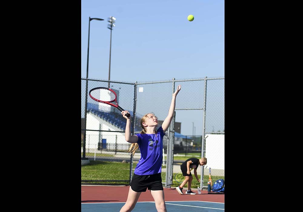 The Jay County High School tennis program held its youth camp this week, with two days added this week to make up for cancellations because of rain. Pictured above, Annie Klopfenstein lines up her serve during Monday morning’s session. (The Commercial Review/Ray Cooney)