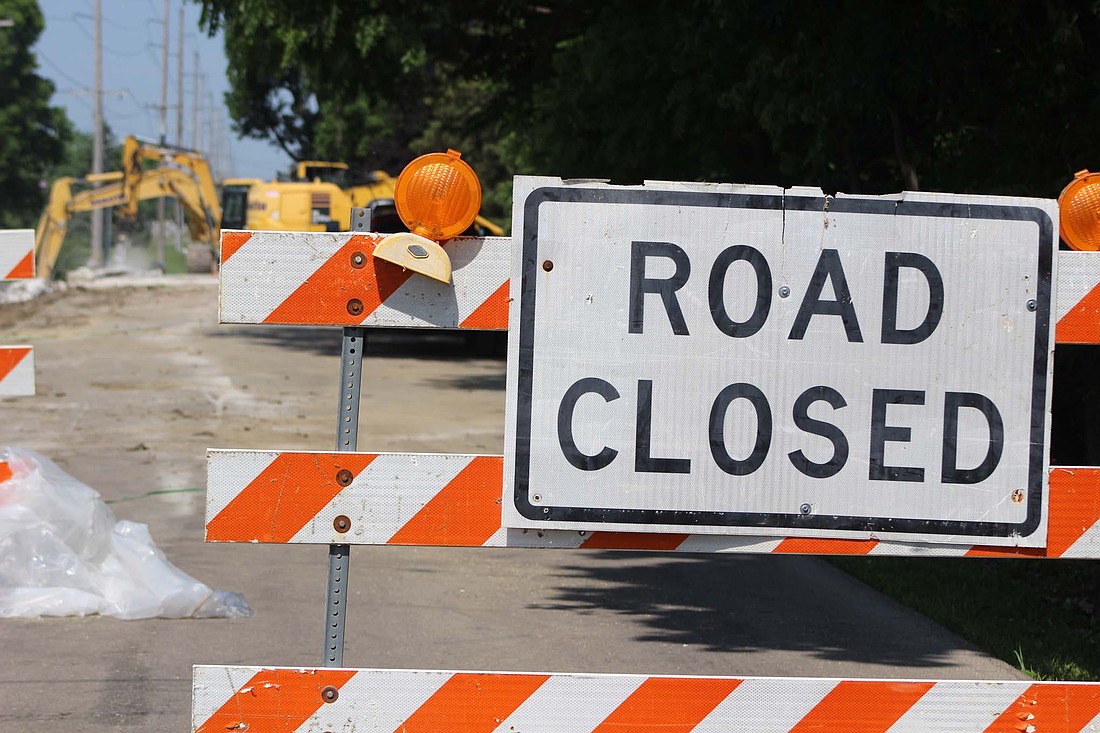 A closed road sign sits along the side of Seventh Street in Portland just west of its intersection with Eighth Street on Tuesday. Construction workers began drilling into the bridge on Seventh Street over the Salamonie River this week, with bridge work to continue for the next 120 days. (The Commercial Review/Bailey Cline)