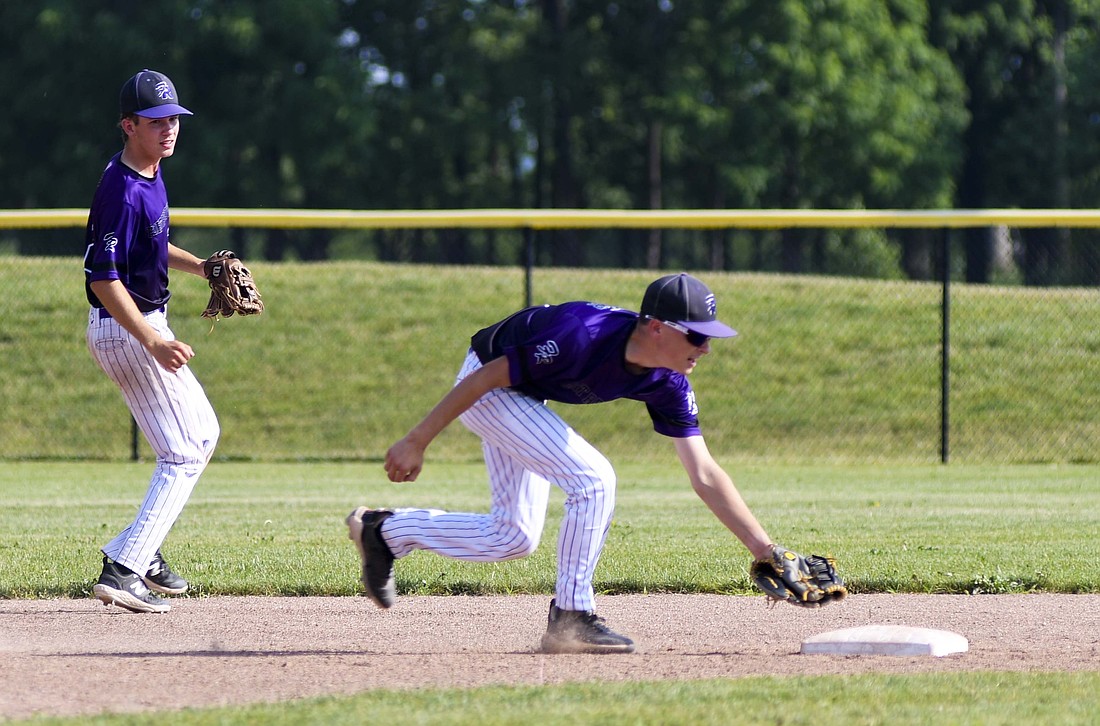 Anthony Roessner, the second baseman for the Fort Recovery ACME baseball team, goes to tag the base with his glove to start a double play during Tuesday’s 12-0 win over Celina. The Indians will host Marion Local in the opening round of the playoffs today. (The Commercial Review/Ray Cooney)