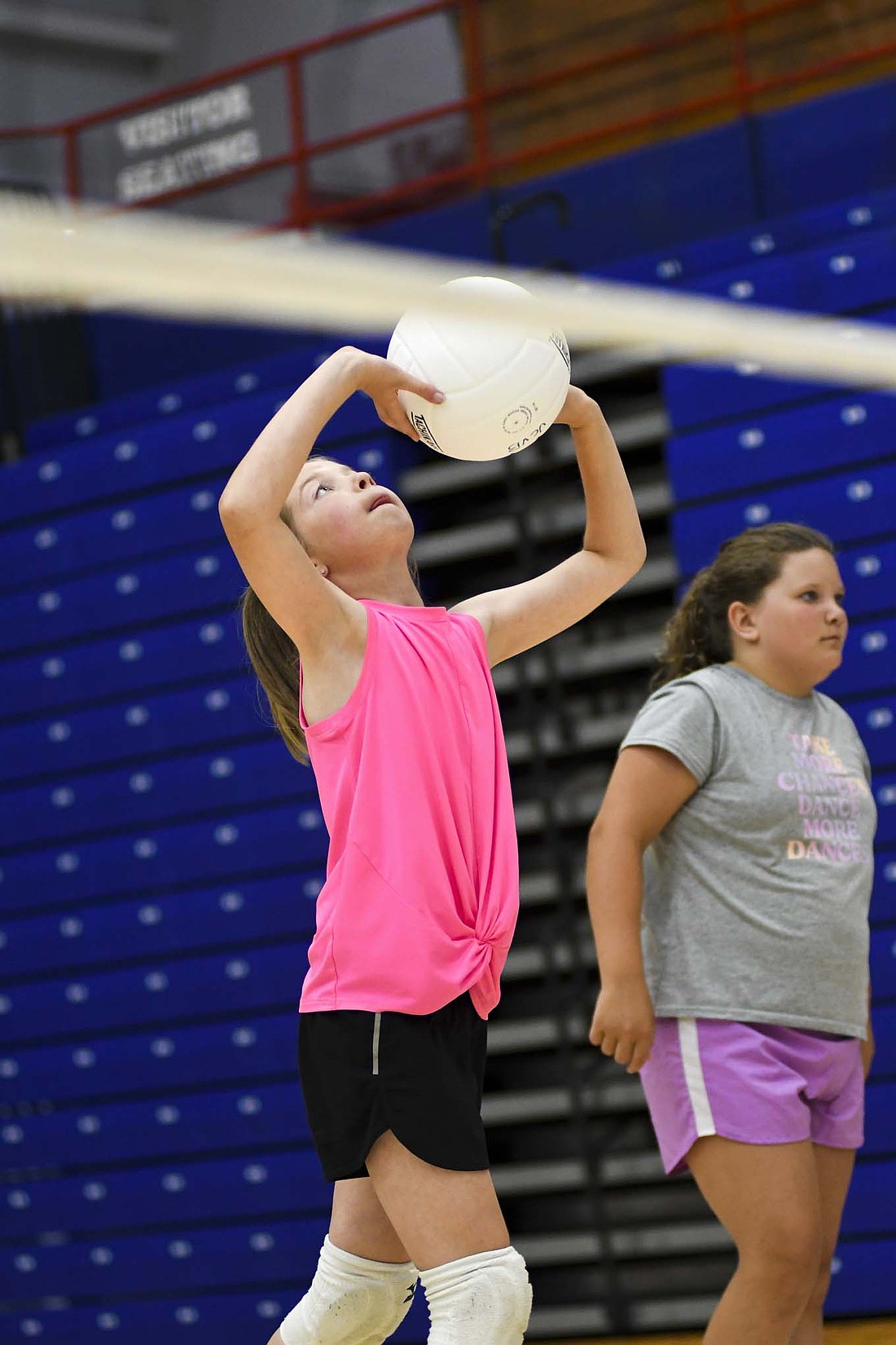 Emily Nieport sets a ball over the net during the Jay County High School volleyball team’s camp for third to fifth graders on Wednesday. (The Commercial Review/Andrew Balko)