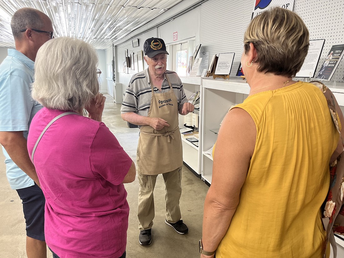 Jim Waechter, center, talks about his display of books by Jay County writers with (from left) Jeff Jackson, Shelba Chenoweth, and Sabra Jackson. Sabra, Shelba’s daughter, grew up in Jay County. She and Jeff now live in Fort Wayne. (The Commercial Review/Louise Ronald)