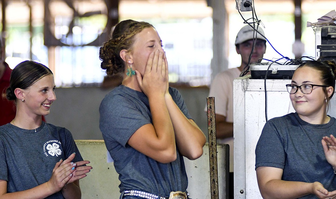 Maria Hemmelgarn reacts early Wednesday evening after she was announced as the winner of the Jay County 4-H large animal supreme showmanship competition. The nine-year 4-H member represented dairy beef, advancing to the supreme showmanship competition for the first time. (The Commercial Review/Ray Cooney)