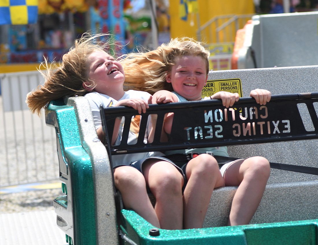 Abby Reef (left) and Maddy Reef laugh while riding the sizzler at the Jay County Fair on Saturday.  The final day of the fair included rides on the midway, a demolition derby at the grandstand and A Touch of Mexico in the Farmer’s Building. The 2026 Jay County Fair is scheduled for June 27 through July 4. (The Commercial Review/Andrew Balko)