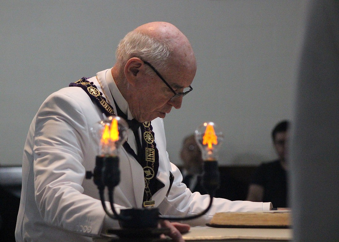 A member of the Grand Lodge of Free and Accepted Masons of Indiana reads from a Bible at Jay Lodge No. 87 in Portland on Saturday. Members of the state and local organizations celebrated Jay Lodge’s 175th anniversary with a rededication ceremony, inviting the public to attend and join for lodge tours, community cookout and outdoor activities, including free popcorn, a bounce house and dunk tank. (The Commercial Review/Bailey Cline)