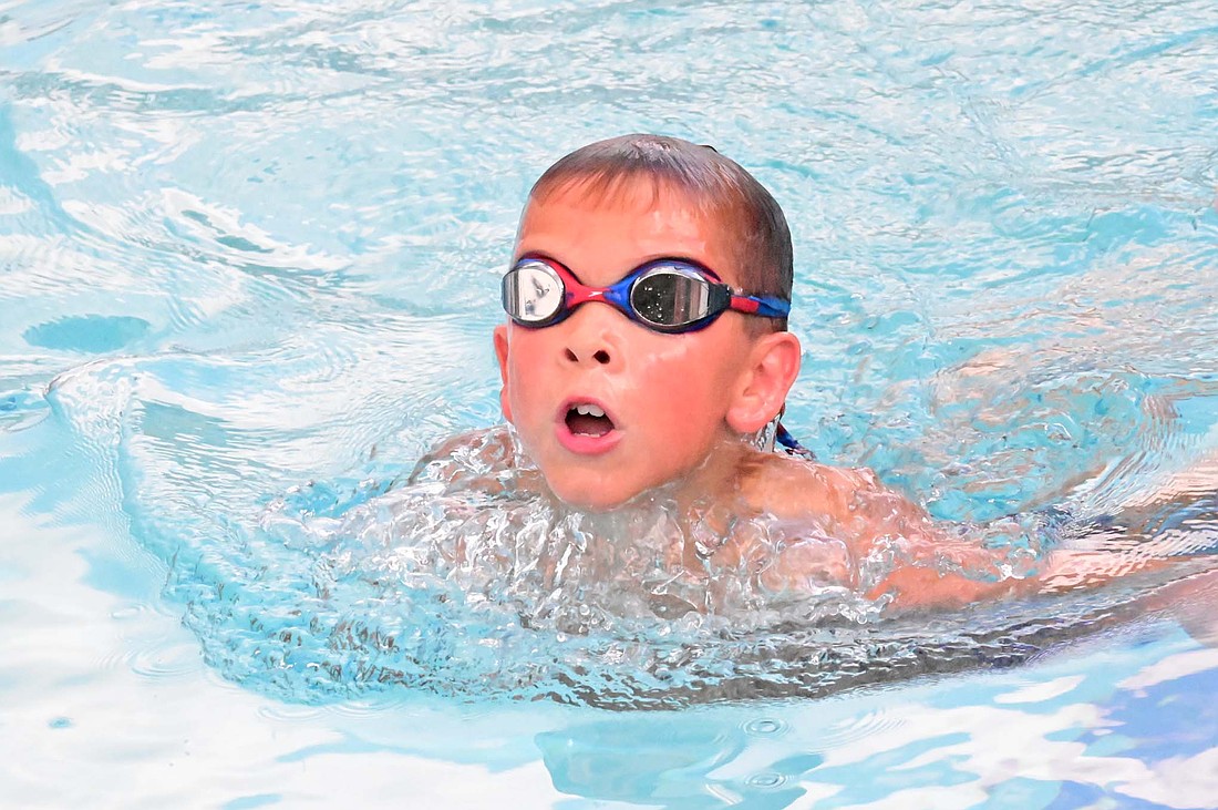 Henry Laux of the Jay County Summer Swim team swims the breaststroke leg of the 8-and-younger boys 100-meter freestyle during the Wabash Valley Conference Championships at Portland Waterpark on Saturday. (Photo provided)