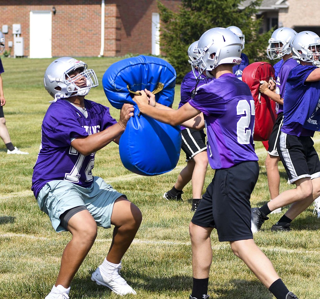 Andrew Martinez blocks a pad during the Fort Recovery High School football team’s camp on Monday. The Indians will travel to Fort Loramie on Friday for a seven-on-seven scrimmage. (The Commercial Review/Andrew Balko)