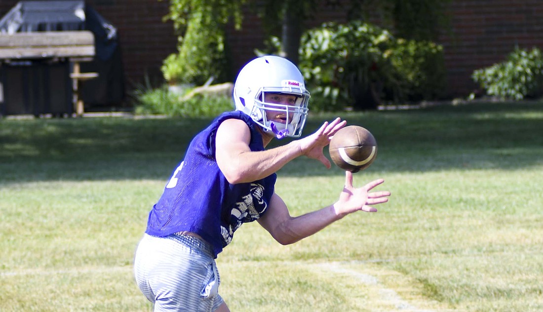 Fort Recovery High School running back Reece Wendel receives a short pass during the football team’s camp on Monday. The Tribe has six more weeks to prepare under first-year coach Wes Wenning before opening the season against Ponitz. (The Commercial Review/Andrew Balko)