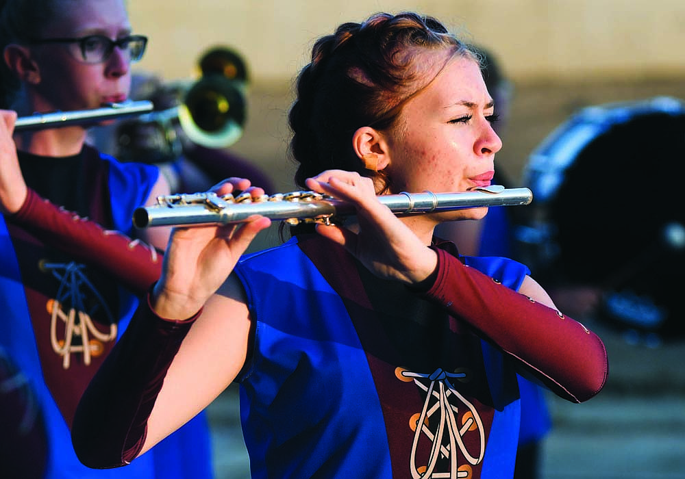 Light shines on the faces of Jay County High School Marching Patriot flute player Brakella Sturgill (above) during Friday night’s Jay County Lions Band Contest at Jay County Fairgrounds. The competition was held in a stand-still format — only music was judged — after rain earlier in the day left part of the track too soggy for marching. The host Patriots scored 31.525 points (out of a possible 50) to finish third, just 0.225 points behind runner-up Anderson. Muncie Central won with 32.175. Winchester (30.225) and Yorktown (23.95) rounded out the top five in the eight-band field. (Three scheduled bands dropped out after the contest shifted to the stand-still format.) (The Commercial Review/Ray Cooney)