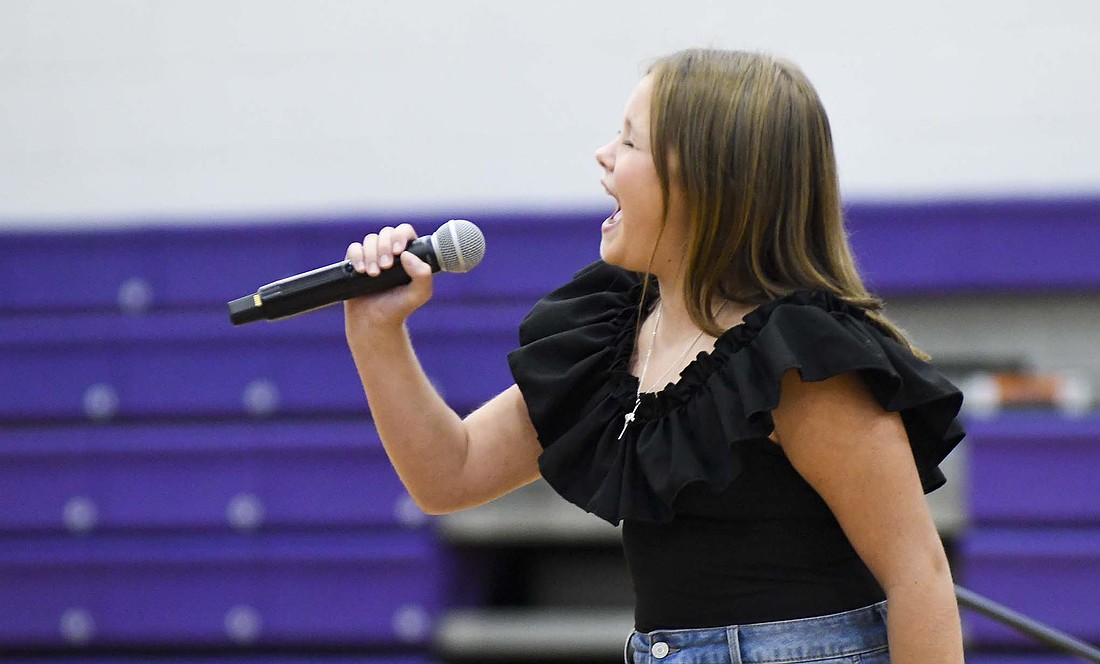 Fort Recovery’s Helena Roessner, who will be a fifth grader this fall, belts out her rendition of “Wrecking Ball” by Miley Cyrus during Fort Recovery Friends of the Arts’ Community Talent Night on Sunday in Fort Site Fieldhouse. The event, which featured a variety of local talent, was moved indoors because of inclement weather. (The Commercial Review/Ray Cooney)