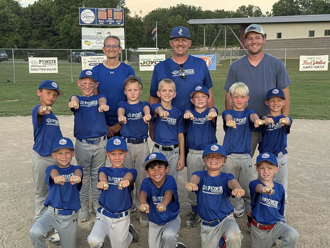 Pictured at left is Pioneer Packaging of the Portland Junior League Rookie baseball league, holding out their rings for taking first place in both the regular season and tournament championship. (Photo provided)
