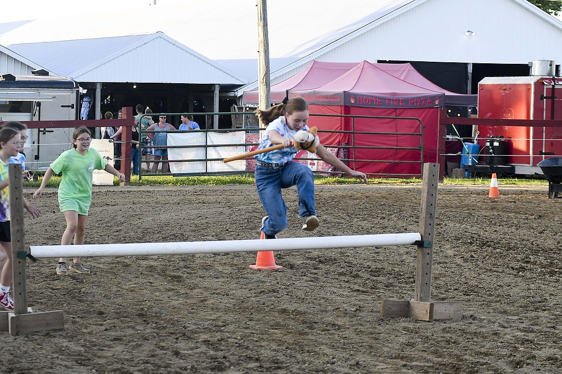 Lilly Logan, 14, Farmland, a relative of Jay County residents, clears the hurdle during the Randolph County 4-H Fair’s Battle of the Barns in the Horse Arena at Randolph County Fairgrounds. The Randolph County 4-H Fair continues through Friday at Randolph County Fairgrounds. (The Commercial Review/Ray Cooney)