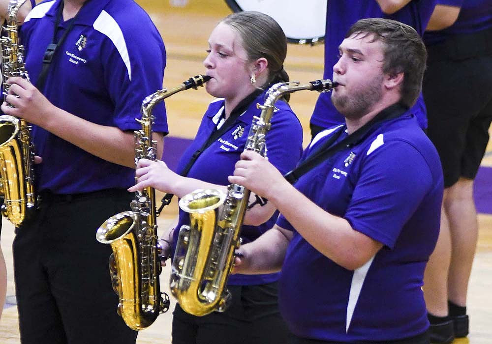 Saxophone players Maddie Wegiel (left), a sophomore, and Jameson Heitkamp, a senior, play Friday during the Fort Recovery High School marching band’s 2025 show reveal and ice cream social on Friday at Fort Site Fieldhouse. (The event was moved indoors from Barrenbrugge Athletic Park because of inclement weather.) The band’s show, based on the movie “Top Gun” features versions of “Take My Breath Away” and “Danger Zone.” (The Commercial Review/Ray Cooney)