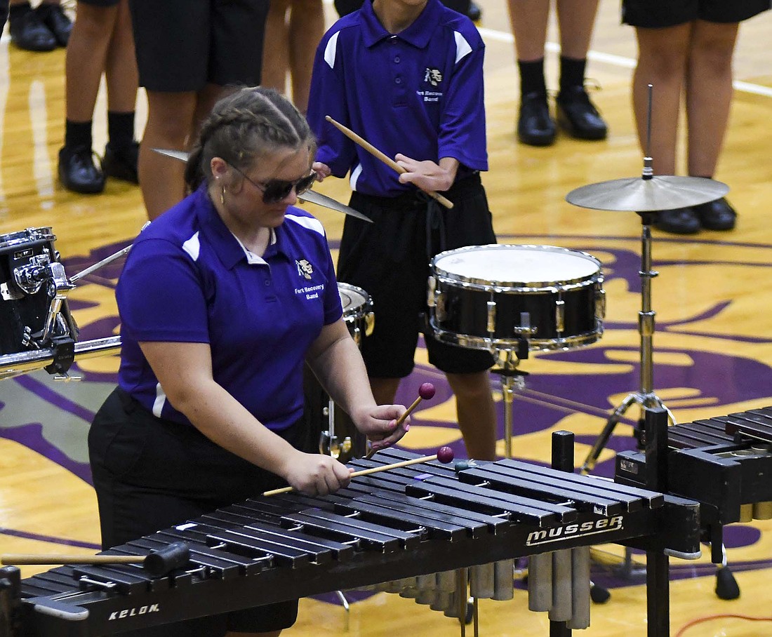Senior Cora Kremer plays the xylophone during the Fort Recovery High School marching band’s show reveal Friday at Fort Site Fieldhouse. This year’s show has a “Top Gun” theme. (The Commercial Review/Ray Cooney)