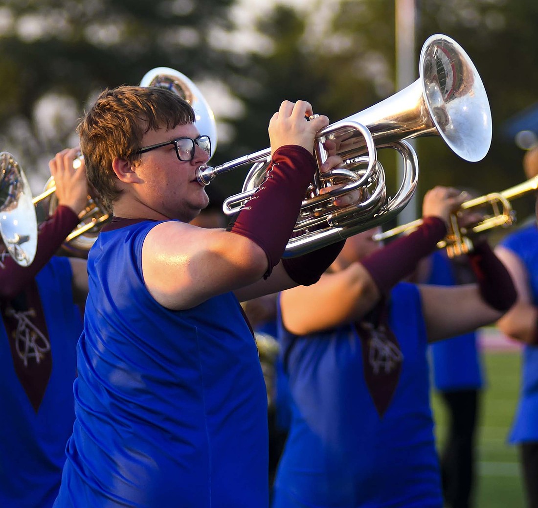 Chase Baxter of the Jay County High School Marching Patriots plays the baritone during the first of two runs of the band’s show — “Consumed” — during its Indiana State Fair preview performance on Tuesday at Harold E. Schutz Memorial Stadium. The state fair competition begins at 9 a.m. Friday with JCHS slated to take the track at 1:18 p.m. Preliminary awards will be at 4 p.m., with the top 16 bands advancing to the finals at 8 p.m. (The Commercial Review/Ray Cooney)