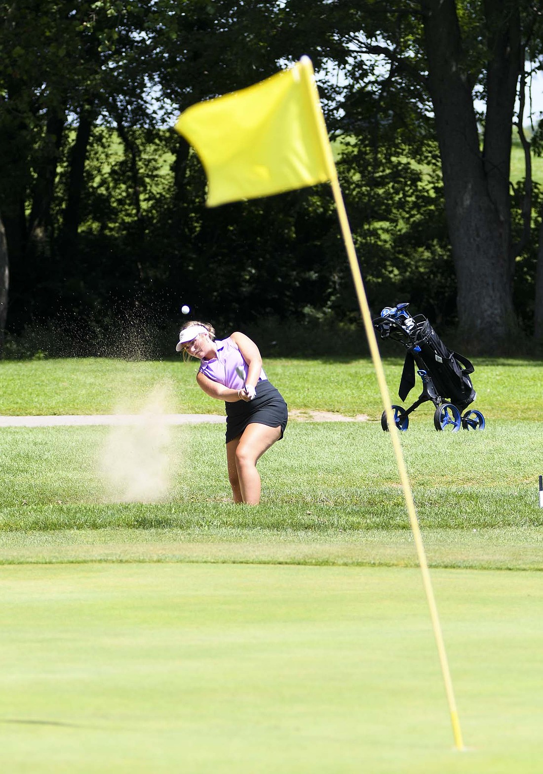 Fort Recovery High School senior Olivia Knapke hits out of the bunker on the third hole at the Union City Golf Country Club on Tuesday afternoon. Knapke finished second in the field of 35 golfers with a round of 47, trailing only teammate Mallory Evers (45) to help the Tribe to the top spot in the Union City Classic. (The Commercial Review/Andrew Balko)