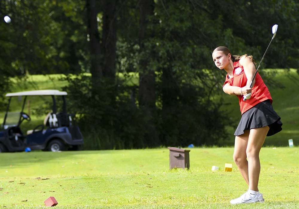 Elizabeth Brunswick of the Jay County High School girls golf team watches her ball sail off the tee of the 15th hole at Wabash Valley Golf Course on Monday during the season opening South Adams Invite. Brunswick bogeyed the 110-yard, par-3 en route to a round of 125 that rounded out the Patriots team score of 484 that took ninth place. (The Commercial Review/Andrew Balko)