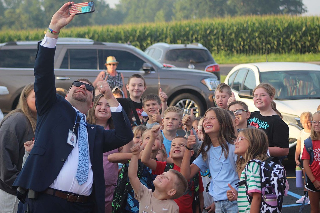 Bloomfield Elementary School principal Ben Dues takes a selfie with students arriving Thursday morning. (The Commercial Review/Bailey Cline)