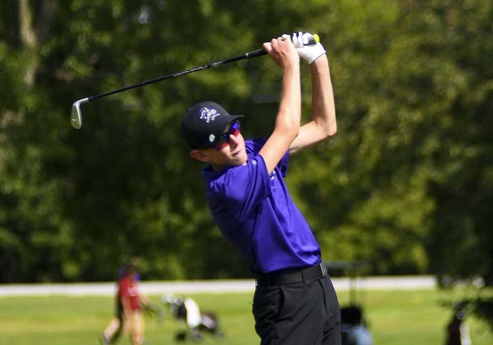 Andrew Rehmert hits an iron shot during Fort Recovery’s match against New Bremen at Portland Golf Club on Thursday. The freshman shot a 44 in the nine-hole match, the Indians’ second-best score and the third-best in the event overall. (The Commercial Review/Ethan Oskroba)