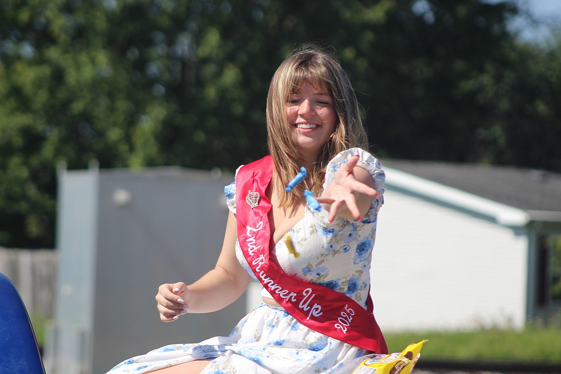 Jasmine Esparza, second runner up in the Miss Jay County pageant, tosses candy to Gas Boom Days paradegoers Saturday. Another festival is scheduled for this weekend, with Glass Days on Saturday in Dunkirk. (The Commercial Review/Bailey Cline)