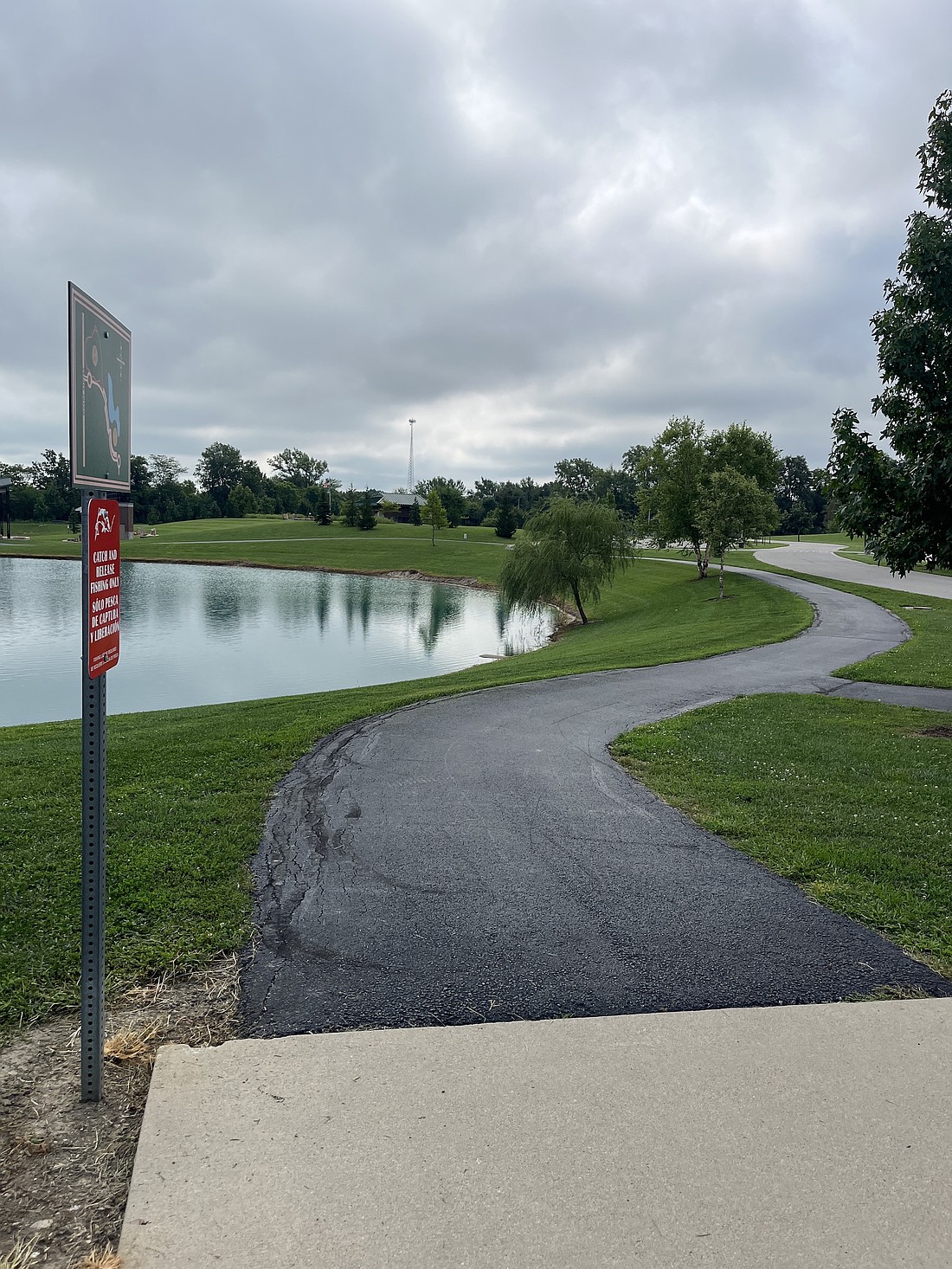 Portland Park Board approved $45,000 in paving work during its meeting Tuesday, including rehabilitating the stretch of the walking path at Hudson Family Park pictured above running east from the playground area toward the amphitheater. During its meeting, the board also discussed potential capital projects and repairs for 2026. The list included additional work on the path and driveway at Hudson Family Park. (The Commercial Review/Ray Cooney)
