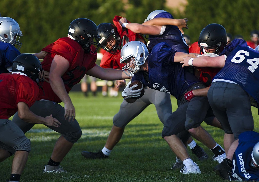 Fort Recovery High School senior Reece Wendel breaks through the line on a carry during the Indians’ scrimmage against Indian Lake on Friday evening. Wendel is the Tribe’s leading offensive returner after converting eight touchdowns on 100.8 rushing yards per game in 2024. (The Commercial Review/Ray Cooney)