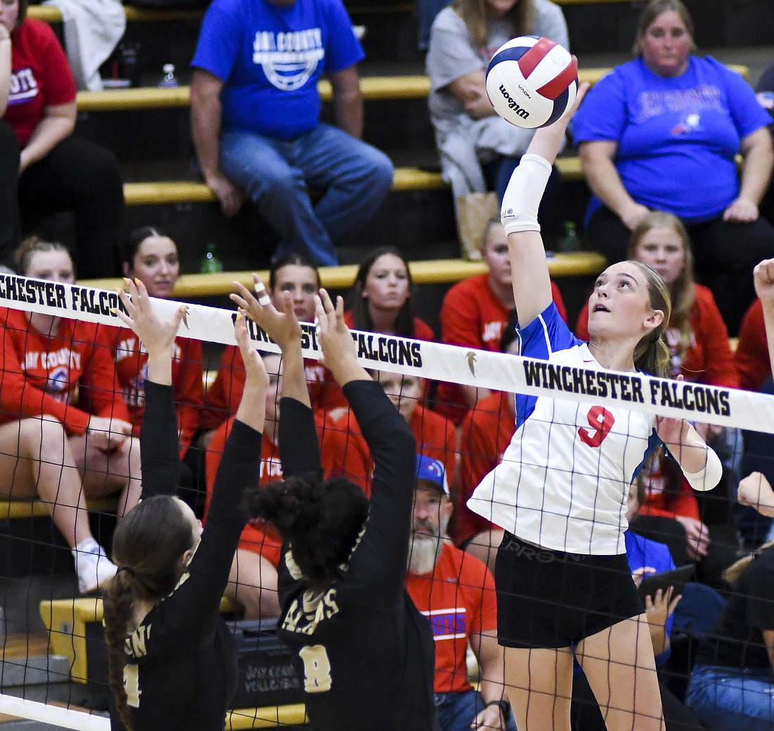 Brenna Schmiesing of the Jay County High School volleyball team elevates to attack over the block effort of Molly Barker (left) and Lilyana Mayberry during Tuesday’s 25-21, 18-25, 25-12, 25-19 win. Schmiesing had nine kills, tying Mayberry for the third most in the match behind Auden Hummel (16) and Hallie Schwieterman (11). (The Commercial Review/Andrew Balko)