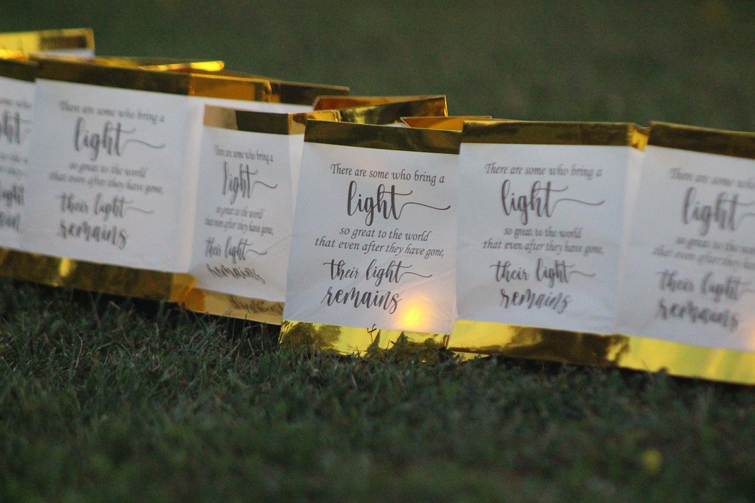 Lanterns flicker along the edge of the pond at Hudson Family Park during Jay County Drug Prevention Coalition’s overdose awareness memorial Friday. The event included guest speakers, a memorial walk and lantern release. (The Commercial Review/Bailey Cline)