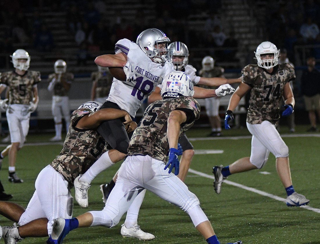 Breaker Jutte, a junior on the Fort Recovery High School football team pushes forward to gain extra yards while one of Allen East’s defenders wraps him up on Friday. Jutte had a handful of key rushes off direct snaps in the 23-16 victory, including a touchdown in the second quarter and two key first downs in the fourth that helped run out the clock. (The Commercial Review/Andrew Balko)