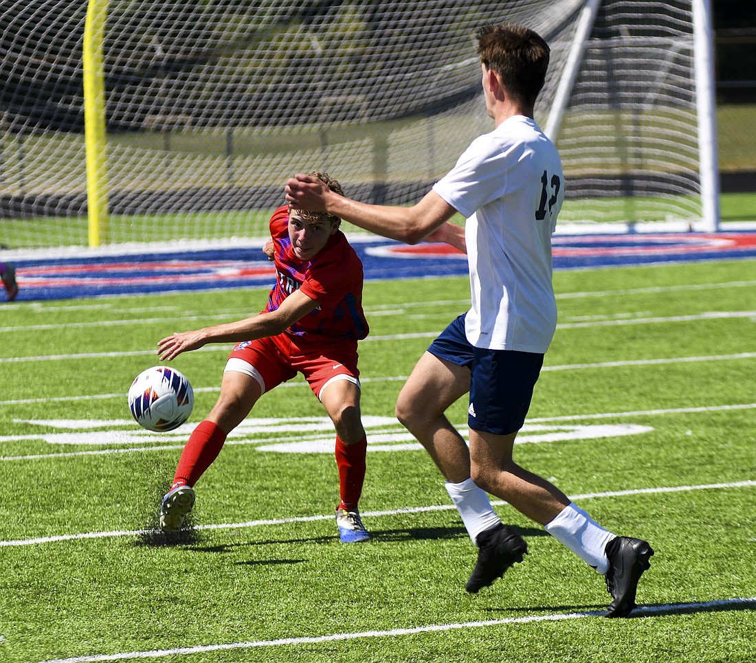 Jay County’s Samuel Wiggins sends the ball upfield in the Patriots’ 3-1 victory over the Woodlan Warriors on Saturday. The freshman helped galvanize the defense as fellow first-year Jacoby Penrod poured in three unanswered goals to lift the Patriots. (The Commercial Review/Ethan Oskroba)