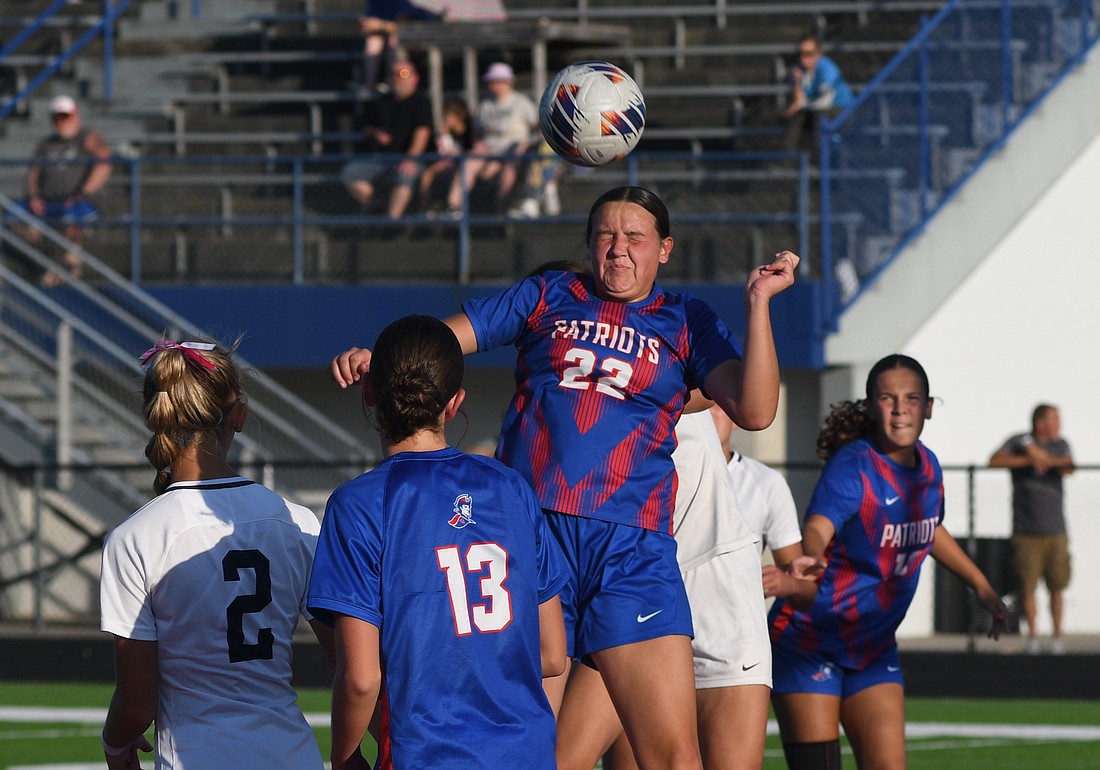 Jay County High School freshman Charlee Peters goes up for a header on a corner kick during the second half of the Patriots' 5-0 loss Thursday to the undefeated Oak Hill Golden Eagles. The next four JCHS games will be on the road, beginning with a visit Saturday to South Adams. (The commercial Review/Ray Cooney)