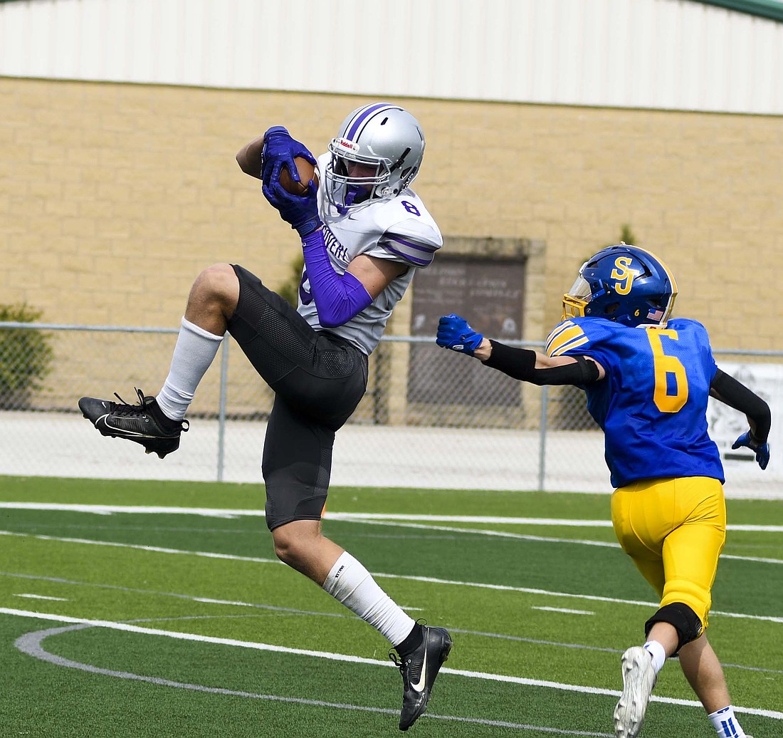 Fort Recovery High School’s Isaac Roessner hauls in an interception during the Tribe’s 41-0 win over St. John’s on Saturday. The Indians picked off the Bluejays twice for 99 yards as the defense locked the game down. (The Commercial Review/Andrew Balko)