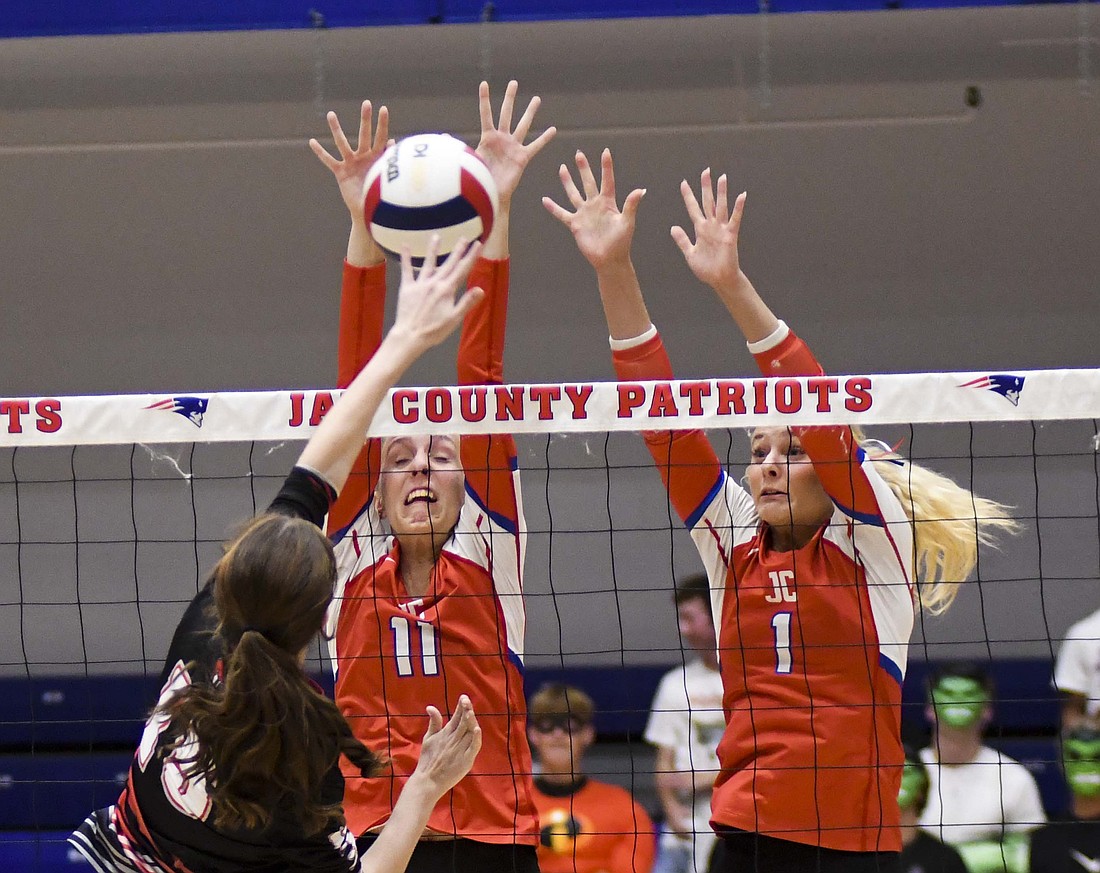 Jay County High School’s Mya Kunkler (11) and Hallie Schwieterman (1) put a block on Blackford’s Elly Huffman during the 25-12, 25-9, 25-10 on Monday. Kunkler tied Maria Hemmelgarn with a team-high four blocks and added seven kills. Schwieteman had one block and two kills. (The Commercial Review/Ethan Oskroba)