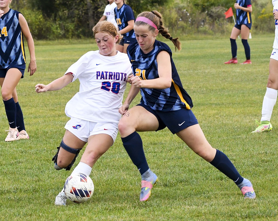 Emma Hatzell, a defender on the Jay County High School girls soccer team, boots a ball away from Delta’s Shiloh Bunch as she drives down field during a 7-0 loss at the hands of the Eagles on Tuesday. The Patriots held Delta to two goals in the entire first half before giving up four goals to Avery Jarrells in the first eight minutes of the second half. JCHS will get another shot at a sectional opponent today as they host the defending champion Yorktown Tigers. (The Commercial Review/Andrew Balko)