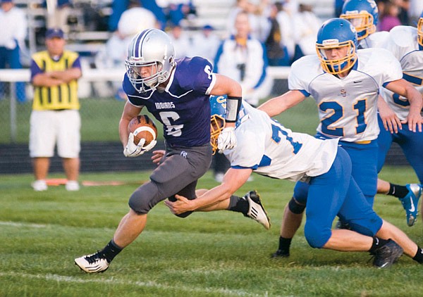 Cole Hull of the Fort Recovery High School football team takes a carry during the September 19, 2014, game against St. John’s 39-7. Cole’s older brother, Perry, helped the Fort Recovery High School athletics department upload film from the football, volleyball and boys and girls basketball teams dating back to the 1992 season. To see the game that Cole Hull played in back in the day, visit youtube.com/@fortrecoveryfilmarchive. (The Commercial Review)