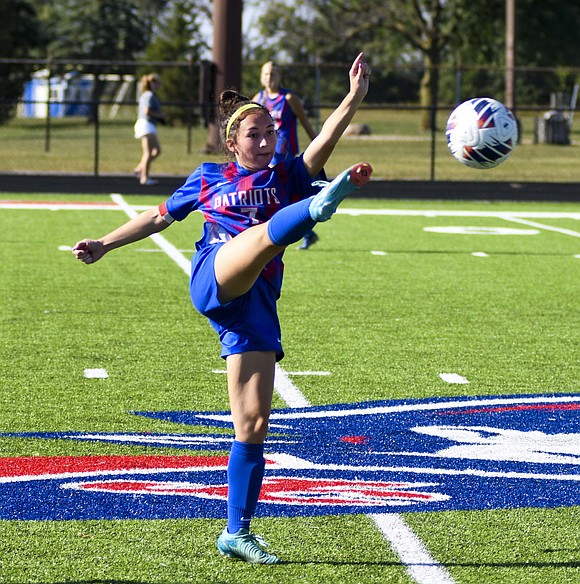 Finley Hatzell of the JCHS girls soccer team gets a high touch on the ball during the Patriots’ 4-0 victory over Heritage on Saturday. The Patriots controlled possession of the ball the entire match, only allowing Heritage to get one look at the goal midway through the second half. (The Commercial Review/Andrew Balko)