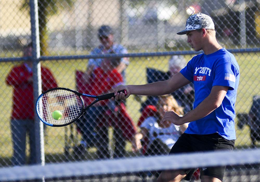 Jay County High School sophomore Nick Snow hits a shot during his match with Alex Miller at No. 1 doubles during the Patriots' 4-1 sectional semifinal win over Union City. Snow, who had just one varsity match under his belt this year, filled in for the injured Kadyn Carpenter in the sectional match. (The Commercial Review/Ray Cooney)